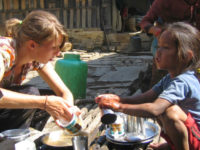 A volunteer Practicing Clean plates in a village