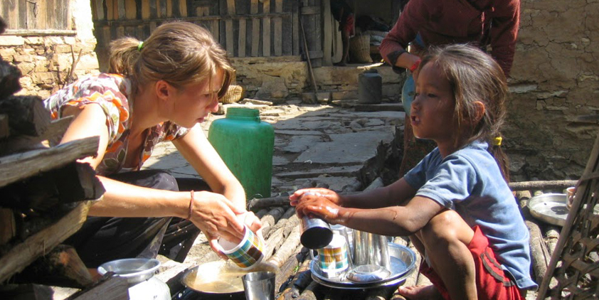 A volunteer Practicing Clean plates in a village