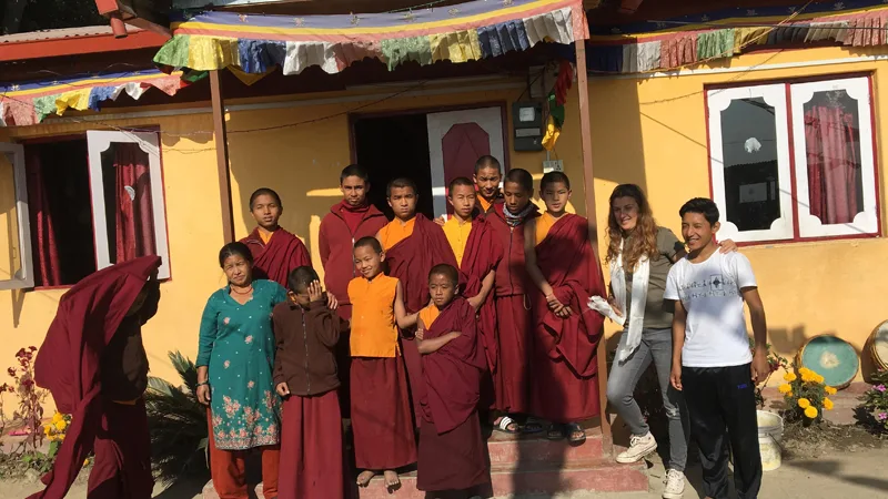 Monks take picture with a volunteer in farewell time.